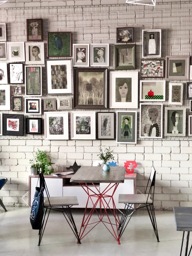 A wall of photos with different frame materials