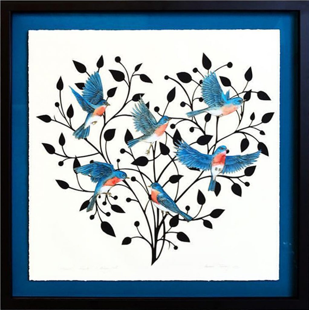 A black frame with blue matting around a heart tree with blue birds.