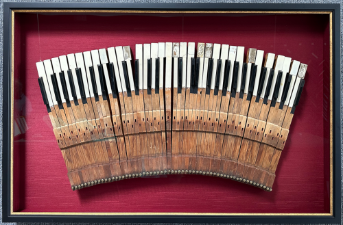 Vintage piano keys in a shadow box.