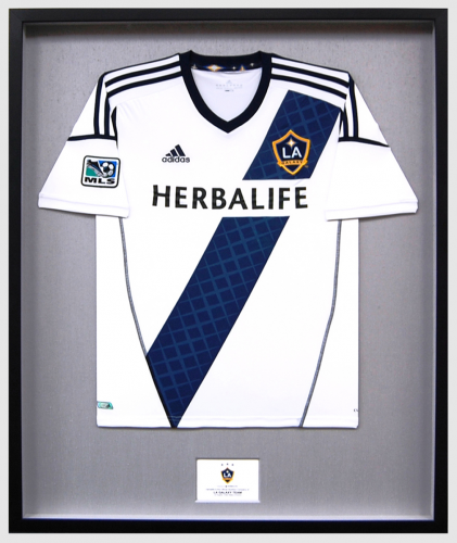 Jersey with sponsors' names in a shadow box.